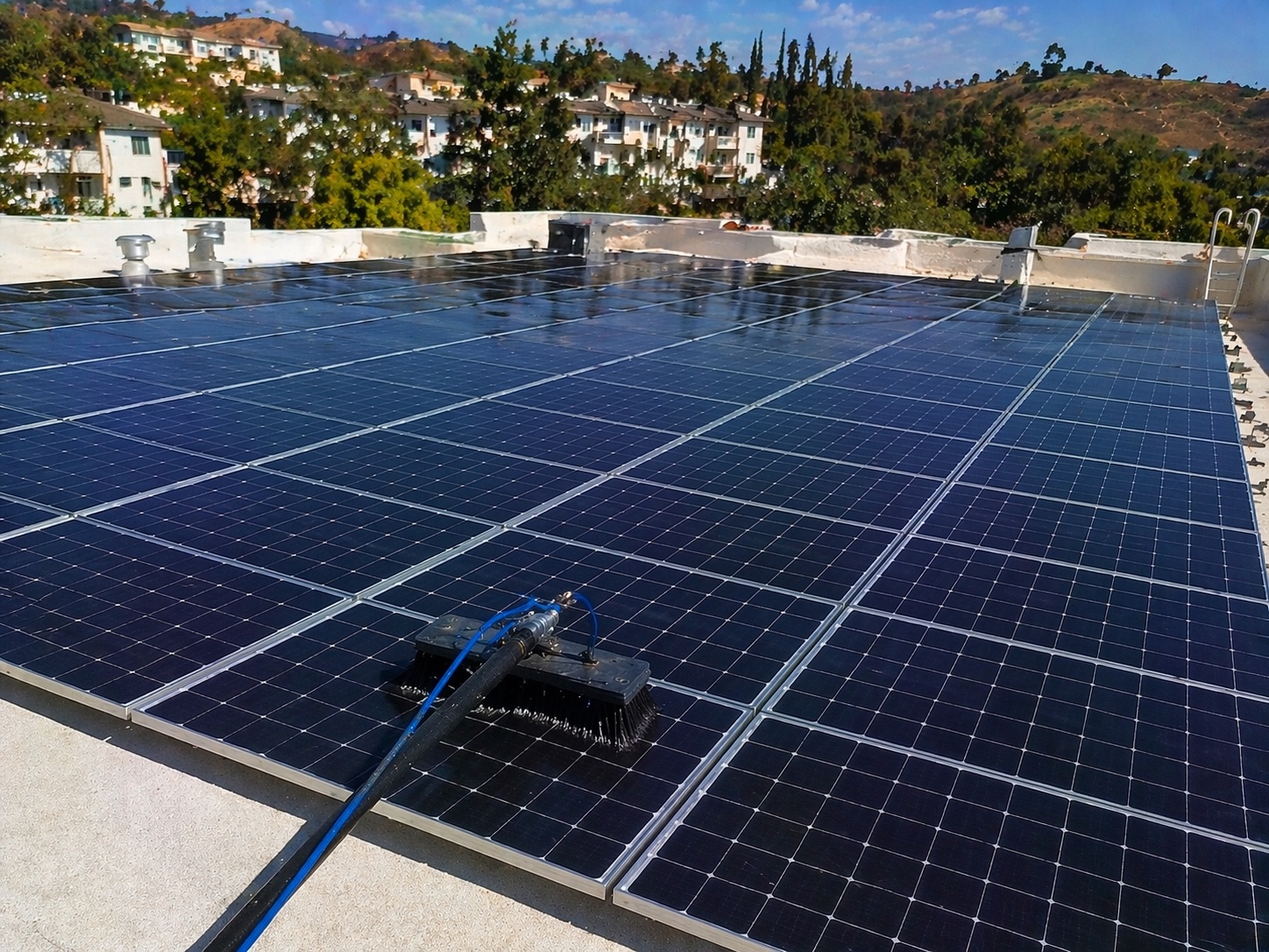 HOA solar panel cleaning at Ladera Ranch complex, Orange County — 48-panel flat-roof array serviced by Bright Mountains Solar Cleaning